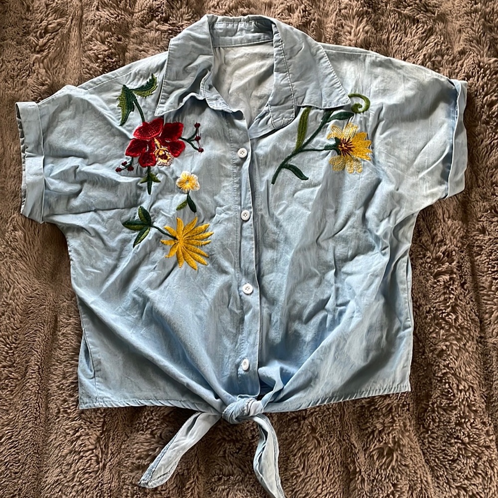 Never worn, cute button down bottom tie embroidered shirt. Light blue.
